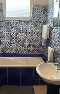 a bathroom with a tub and a sink at Villa Funchal in Funchal