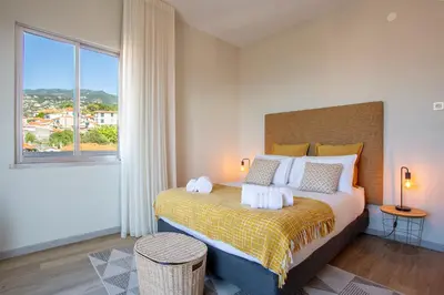 a bedroom with a bed with towels on it at Villa Funchal in Funchal