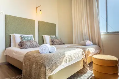 two beds in a room with towels on them at Villa Funchal in Funchal