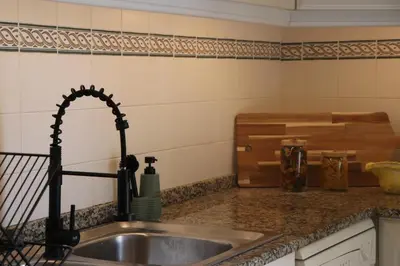 a kitchen counter with a sink and a counter top at Pé n' Areia Beach House Porto Santo in Porto Santo