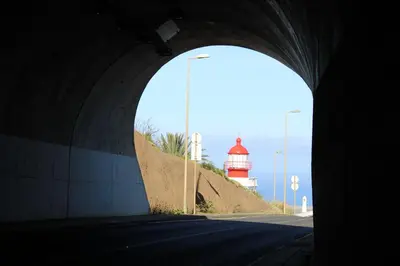a tunnel with a light house and a lighthouse at Casa da Ponta in Ponta do Pargo