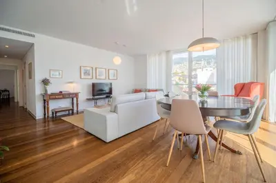 a white kitchen with white cabinets and appliances at The Plaza Apartment in Funchal