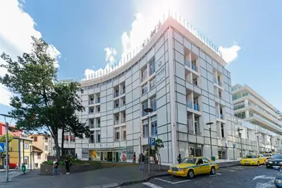 a group of people walking in front of a building at The Plaza Apartment in Funchal
