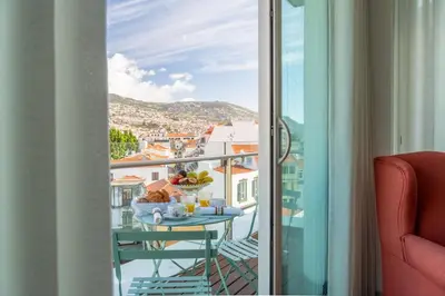 a bathroom with a sink and a toilet and a tub at The Plaza Apartment in Funchal