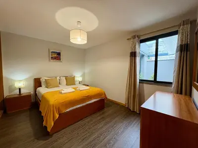 a bedroom with a bed and a large window at Marialina, By OP in São Vicente