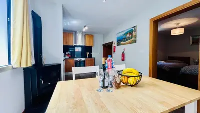 a kitchen with a wooden table with a bowl on it at Marialina, By OP in São Vicente