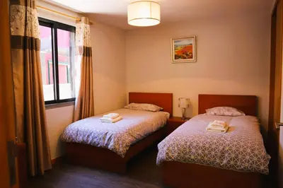 a bedroom with two beds and a window at Marialina, By OP in São Vicente