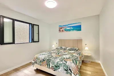 a bedroom with a bed and a window at A Casa Azul - Arco da Calheta in Arco da Calheta