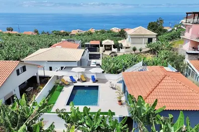 an aerial view of a house with a swimming pool at A Casa Azul - Arco da Calheta in Arco da Calheta