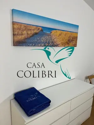 a flat screen tv sitting on top of a table at Casa Colibri I in Luz
