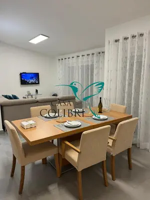 a dining room table with chairs and a sign that says glass citizen at Casa Colibri I in Luz