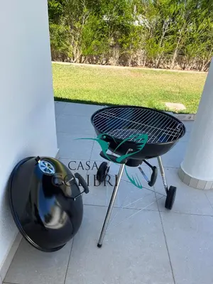 a barbecue grill sitting on a patio next to at Casa Colibri I in Luz