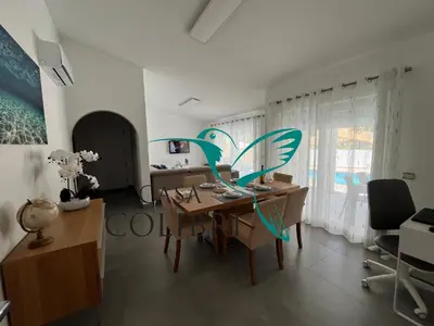 a dining room with a table and some chairs at Casa Colibri I in Luz