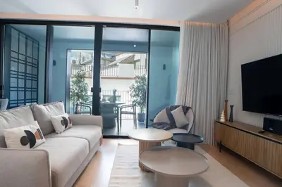 a living room with a couch and a tv at Empire Luxury Suite - Savoy Insular in Funchal