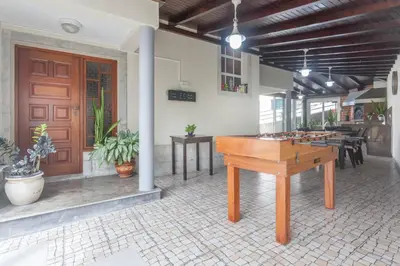 a room with a ping pong table in front of a building at Jango Paradise in Funchal