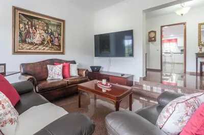 a living room with leather furniture and a flat screen tv at Jango Paradise in Funchal
