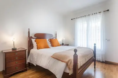 a bedroom with a bed and a dresser and a window at Jango Paradise in Funchal
