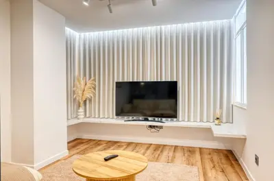 a living room with a television and a table at Machico Fachos View, a Home in Madeira in Machico
