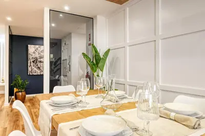 a dining room with a table and chairs and a mirror at Machico Fachos View, a Home in Madeira in Machico