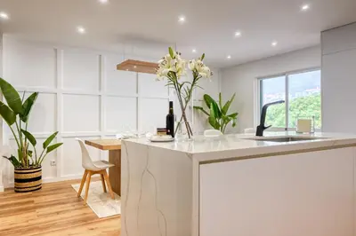 a kitchen with a counter with a vase of flowers on it at Machico Fachos View, a Home in Madeira in Machico