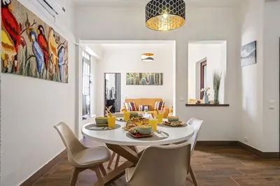 a dining room with a white table and chairs at Funchal Ocean Terrace APT in Funchal