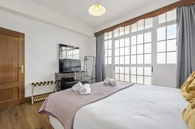 a bedroom with a large bed with towels on it at Funchal Ocean Terrace APT in Funchal
