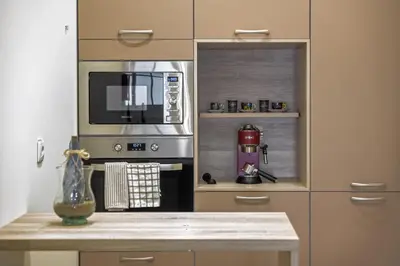 a kitchen with a microwave and a coffee maker at Funchal Ocean Terrace APT in Funchal