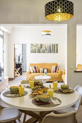 a table with food on it in a living room at Funchal Ocean Terrace APT in Funchal