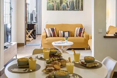 a living room with a table with food on it at Funchal Ocean Terrace APT in Funchal