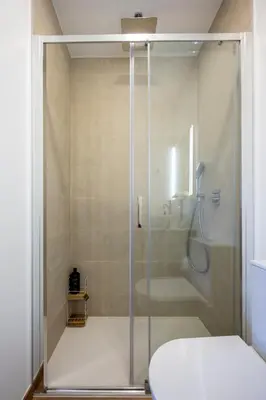 a bathroom with a shower with a toilet and a sink at Casa Clara in Vila do Bispo