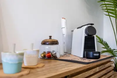a table with a coffee maker and two drinks on it at Casa Clara in Vila do Bispo
