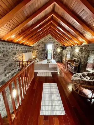 a large room with a bed and a wooden ceiling at Palheiro Mar by Olá Madeira in Paul do Mar