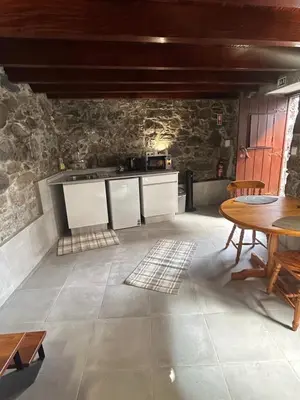 a kitchen and dining room with a table and chairs at Palheiro Mar by Olá Madeira in Paul do Mar