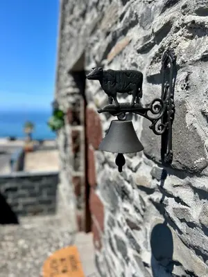 a bell on the side of a stone wall at Palheiro Mar by Olá Madeira in Paul do Mar