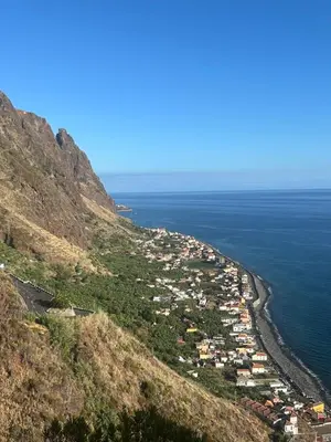 a town on a hill next to the ocean at Palheiro Jardim by Olá Madeira in Paul do Mar