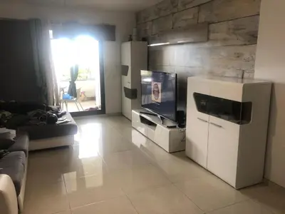 a living room with a white refrigerator and a tv at Magic Paradisus guest in Caniço