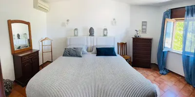 a bedroom with a large bed and a mirror at STUNNING BEACH PENTHOUSE Best Views In Luz in Luz