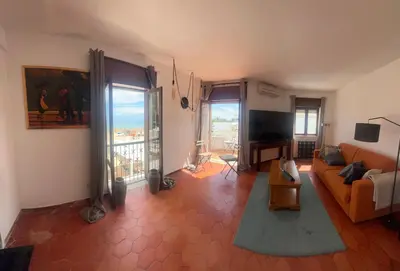 a living room with a couch and a television at STUNNING BEACH PENTHOUSE Best Views In Luz in Luz
