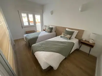 a bedroom with two beds and a window at Casa Dolce Farniente in Luz