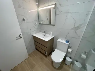 a bathroom with a toilet and a sink and a mirror at Casa Dolce Farniente in Luz