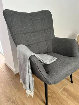 a gray chair with a blanket on the back of it at Casa Dolce Farniente in Luz