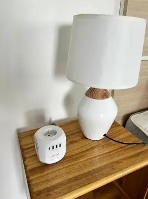 a table with a lamp and a alarm clock on it at Casa Dolce Farniente in Luz