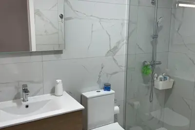 a bathroom with a shower and a toilet and a sink at Casa Dolce Farniente in Luz