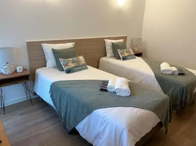 two beds in a hotel room with towels on them at Casa Dolce Farniente in Luz