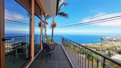 a balcony with a table and a view of the ocean at Casa Clementine by LovelyStay in Funchal