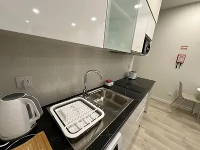 a kitchen with a sink with a keyboard on the counter at Serenity Studio in Caniço