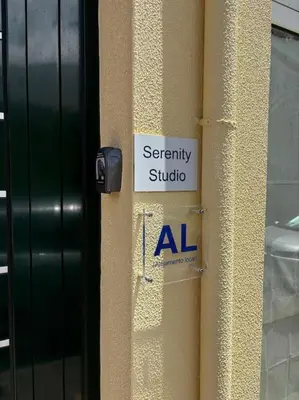 a sign on the side of a building at Serenity Studio in Caniço