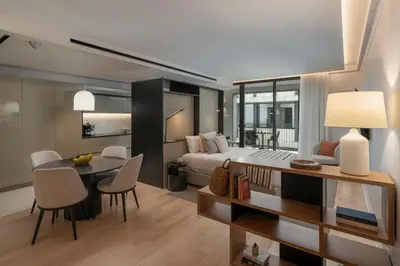 a bedroom and living room with a bed and a table at Savoy Insular VI by An Island Apart in Funchal