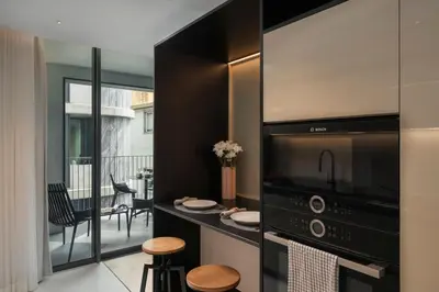 a kitchen with a large microwave and a balcony at Savoy Insular VI by An Island Apart in Funchal