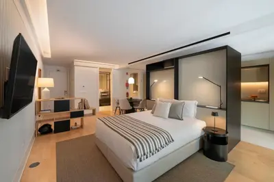 a hotel room with a bed and a television at Savoy Insular VI by An Island Apart in Funchal